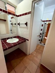 a bathroom with a sink and a mirror at HOTEL BUGAMBILIAS in Oaxaca City