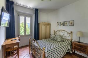 Tempat tidur dalam kamar di La Locanda di Adele - Il Giardinetto B&B