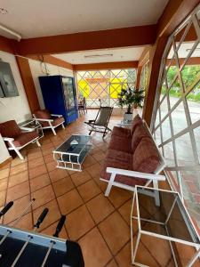 a living room with a couch and a table at HOTEL BUGAMBILIAS in Oaxaca City