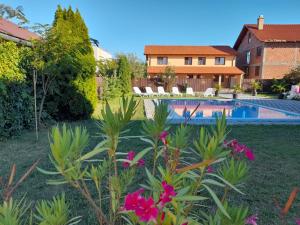 a backyard with a swimming pool and a house at Casa Sannicolau in Sînnicolau Mare