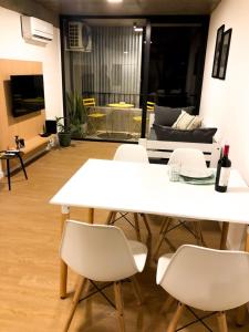 einen weißen Tisch und Stühle im Wohnzimmer in der Unterkunft Cilveti 468 departamento con cochera, excelente ubicación in Rosario
