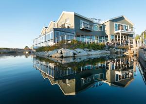 a building next to a body of water at The Boathouse in Kennebunkport