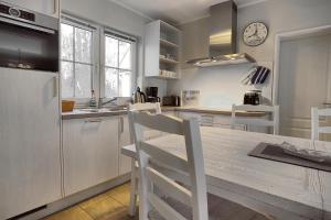 a kitchen with a wooden table and a counter top at Am Deich 43 in Zingst