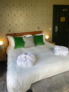 a bedroom with a bed with towels on it at The Waterman's Arms in London