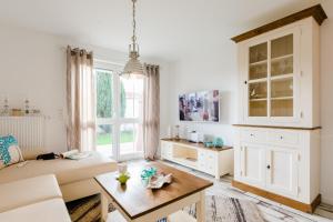 a living room with a couch and a table at Whg 10 - Laura in Zingst