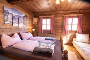 a bedroom with a bed in a log cabin at Loya Chalet WILD32 in Oberau