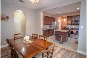 a kitchen and dining room with a wooden table and chairs at Florida St Nice Remodeled 3BR/2BA Near Downtown in San Antonio