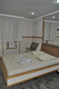 a bedroom with a large bed and a window at Hotel Casa Blanca - Adults Only in Rio de Janeiro