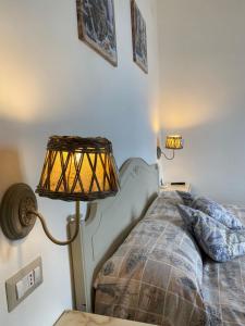 a bedroom with a bed and a lamp on a table at GIARDINO SUL MARE in Amalfi