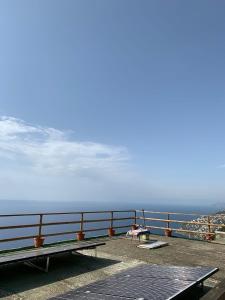 a view of the ocean from a pier with benches at GIARDINO SUL MARE in Amalfi
