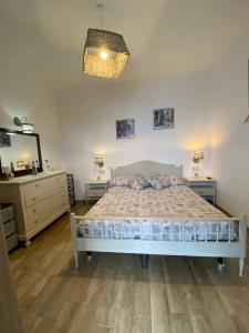 a bedroom with a bed and a dresser and a mirror at GIARDINO SUL MARE in Amalfi
