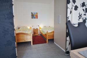a small room with two beds and a doorway at An der Allee 20 B in Dahme