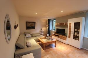 a living room with a couch and a table at Ferienhaus Bettina in Stolberg