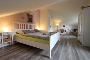 a bedroom with a large bed and a dining room at Ferienhaus Bettina in Stolberg