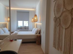 a hotel room with a bed and a mirror at Hotel Alexandra in Skala