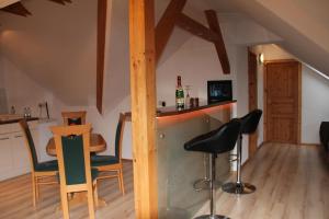 a room with a bar with chairs and a table at Ferienwohnung mit Balkon in Sehmatal