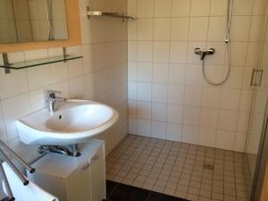 a bathroom with a sink and a shower at Mahari in Friedenstal