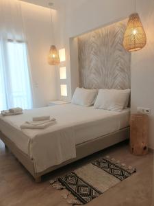 a bedroom with a large bed with two towels on it at Hotel Alexandra in Skala