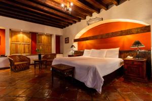a bedroom with a large bed in a room at Hostería San Felipe in Pátzcuaro