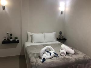 a bedroom with two stuffed animals on a bed at Mi habitat holbox-Maravilla natural in Holbox Island +129 photos