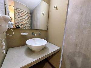 a bathroom with a sink and a mirror at Viaggio Urbano Business in Bogotá