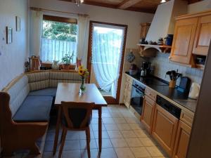 a kitchen with a small table and a kitchen with a couch at Sommerruhe in Titisee-Neustadt