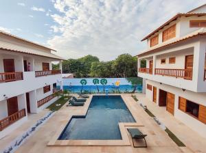 an image of a swimming pool in the middle of a building at Pousada Brisas in Jijoca de Jericoacoara