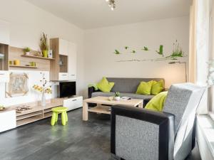 a living room with a couch and a table at Wiesenstraße 2 Whg 1 in Zingst