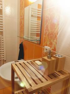 a bathroom with a sink and a toilet and a mirror at Apartmán JaFi Lipno nad Vltavou in Lipno nad Vltavou