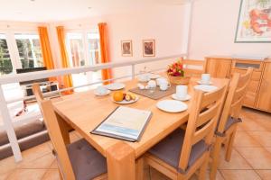 a dining room with a table with a tablet on it at IW - Komfort-Apartment Im Winkel 13 - FERIENDOMIZIL HOLLICH in Grömitz