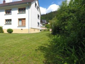 a house with a yard next to a building at Haus Post EG-Wohnung in Todtnau