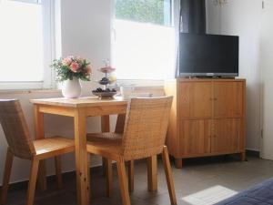 a dining room table with two chairs and a television at Haus Fritz in Dahme