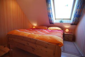 1 dormitorio con cama de madera y ventana en Fehmarn-OstseeferienFewoAnders31593, en Neue Tiefe Fehmarn