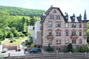 an old house with a car parked in front of it at Haus Bethania Ferienwohnung medio in Bad Kissingen