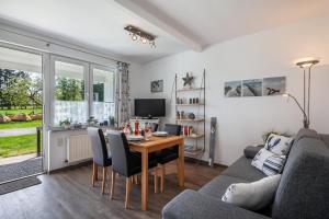 a living room with a table and a couch at Fischereihof Liebe - 69177 in Süsel