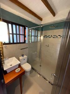 a bathroom with a shower and a toilet and a sink at Monasterio San Agustín, Colombia in San Agustín