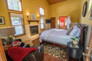 a bedroom with a bed and a fireplace at Elliott House Boutique Inn in Shaver Lake