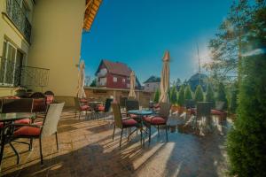a patio with tables and chairs in a restaurant at Apartments Bramar in Zlatibor