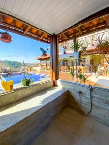 a balcony with a view of a swimming pool at Pousada Quintal da Lua in Capitólio