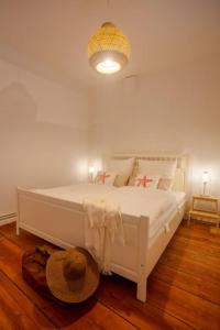 a bedroom with a white bed with a hat on the floor at Apartment No2 in Stralsund