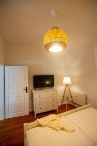 a bedroom with a bed and a television and a lamp at Apartment No2 in Stralsund