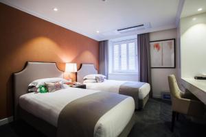 Ein Bett oder Betten in einem Zimmer der Unterkunft The Grand Hotel Myeongdong