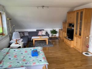 a living room with a couch and a table at Ferienwohnung-Lilienweg in Hilter