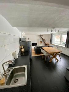 a kitchen and dining room with a sink and a table at Ferienwohnung Winterberg Lodge in Winterberg