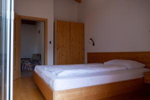 Schlafzimmer mit einem großen Bett mit einem Kopfteil aus Holz in der Unterkunft Ferienwohnung im Haus Texel VII in Rabland