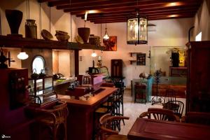 a kitchen with a table and chairs in a room at Posada de Maria Hotel Boutique & Spa in Durango