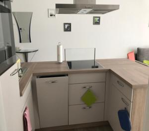 a kitchen with a sink and a counter top at Moderne Ferienwohnung im Herzen von Bad Neustadt in Bad Neustadt an der Saale