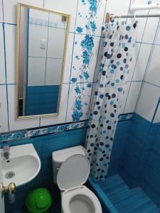 a bathroom with a toilet and a sink and a mirror at La Esquina de Doña Julia in Lima