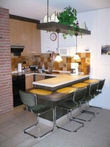 a kitchen with a table and chairs in it at Appartment 3737 in Tossens in Butjadingen OT Tossens