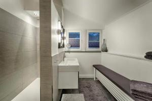 a white bathroom with a sink and a window at "Villa Anker" 1 Etage - rechts in Fehmarn